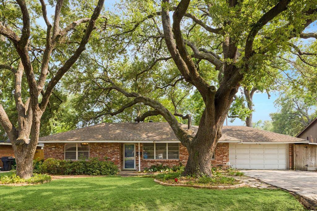 Welcome to 8721 Greiner, a charming home with two incredibly large and beautiful oak trees.