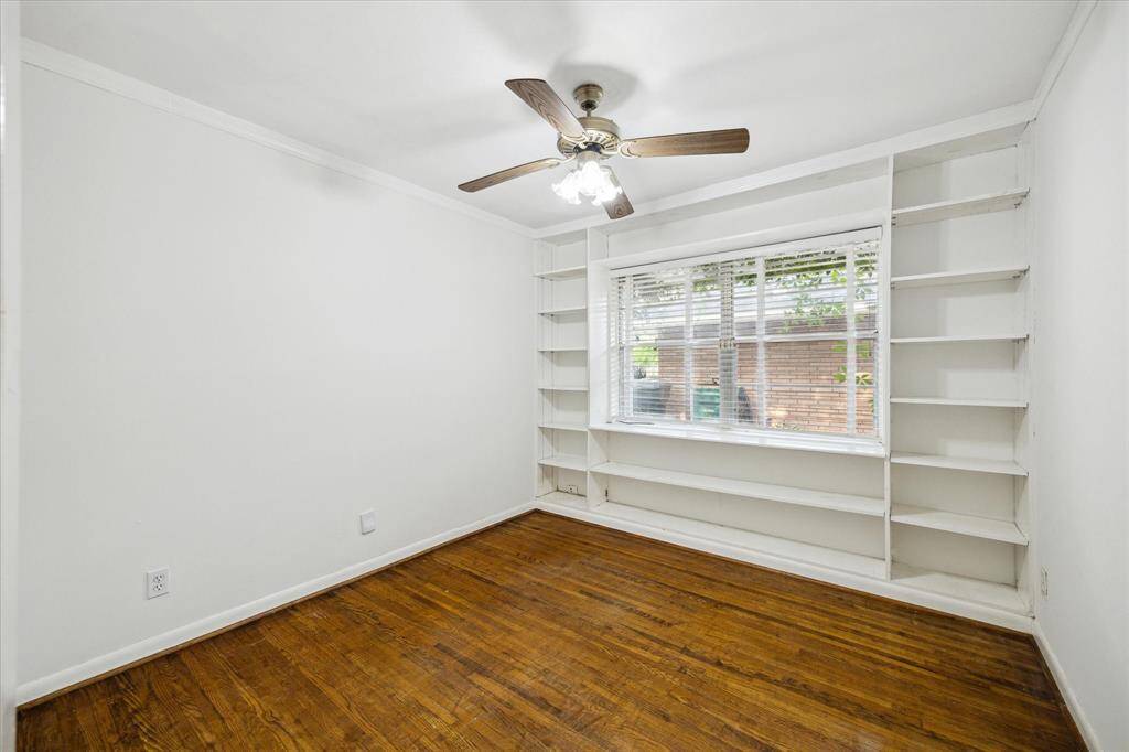 Middle secondary bedroom with a nice wall of adjustable built-in shelves.