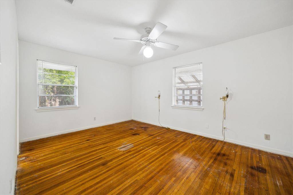 Primary bedroom with windows on three sides.