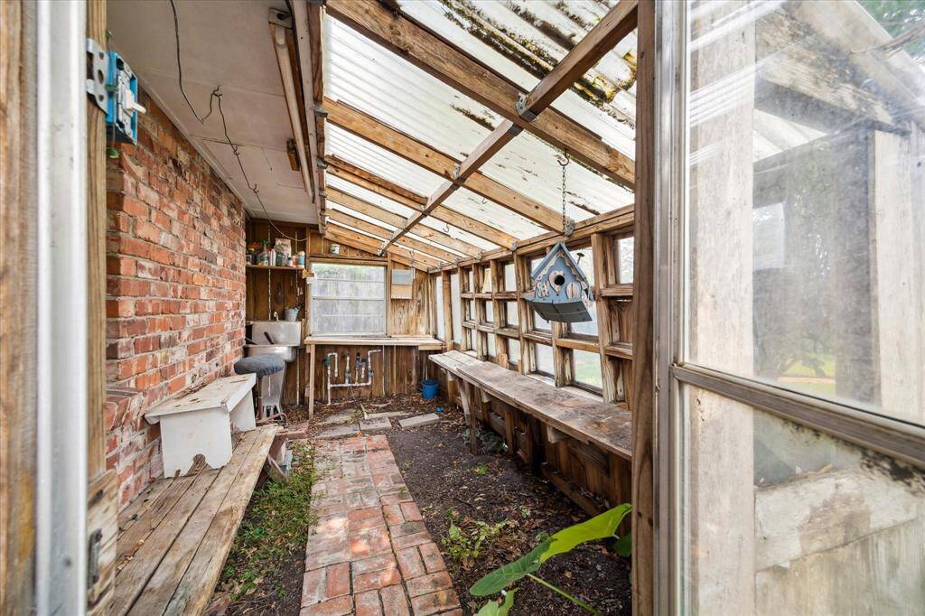 Nice-sized greenhouse in the backyard for all your gardening needs.