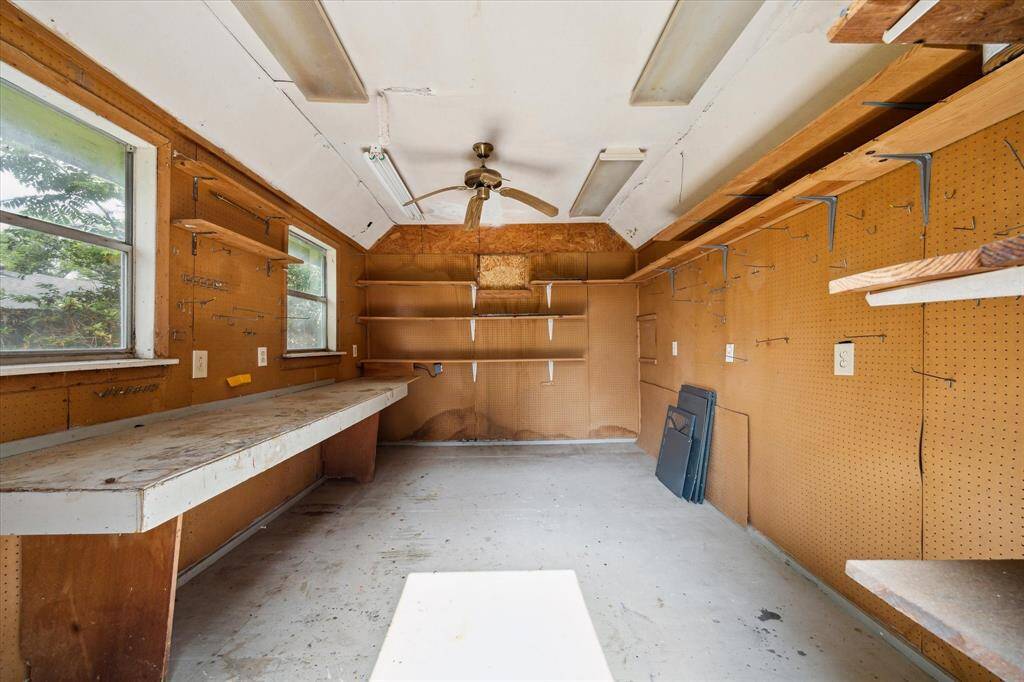The workshop shed is ready for your projects with a peg board, lights, and outlets for your tools.