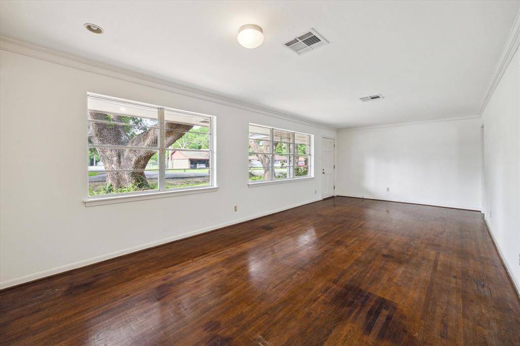 The living room is wide and was designed to also include the dining room on the opposite end.