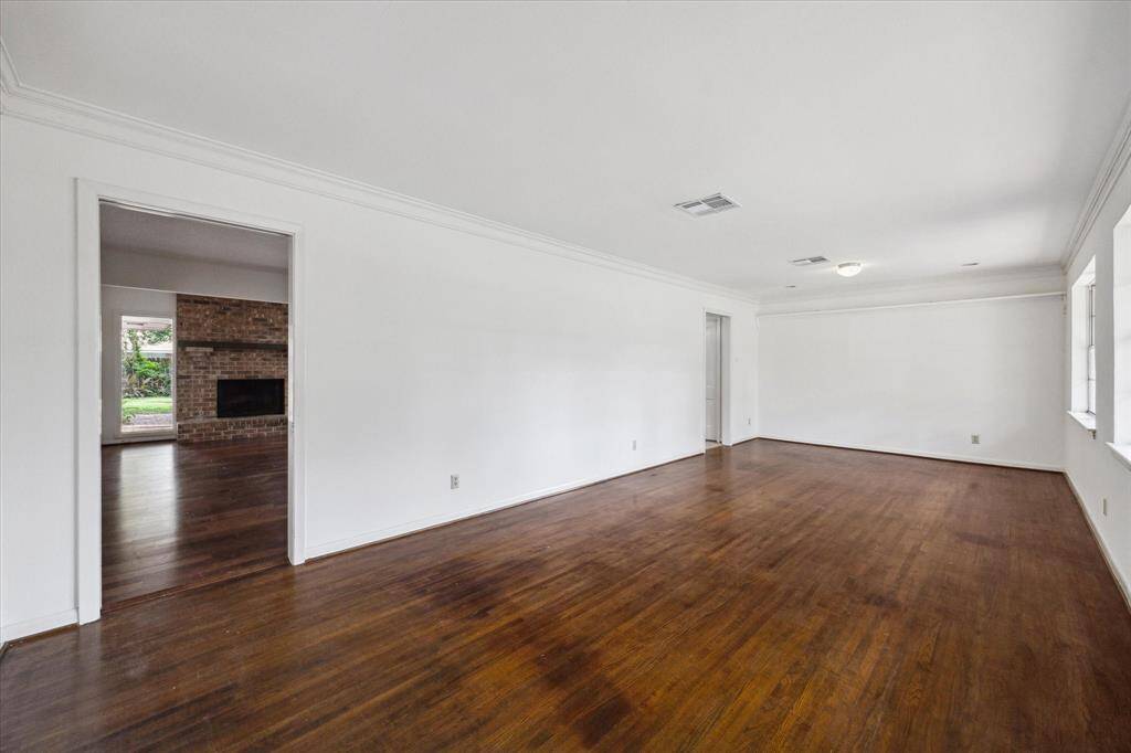This is the view from the entrance and the doorway in the back dining room space leads to the kitchen.
