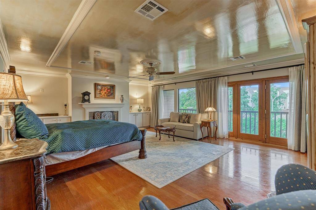 Primary Suite with soaring ceilings, fireplace, sitting room & more