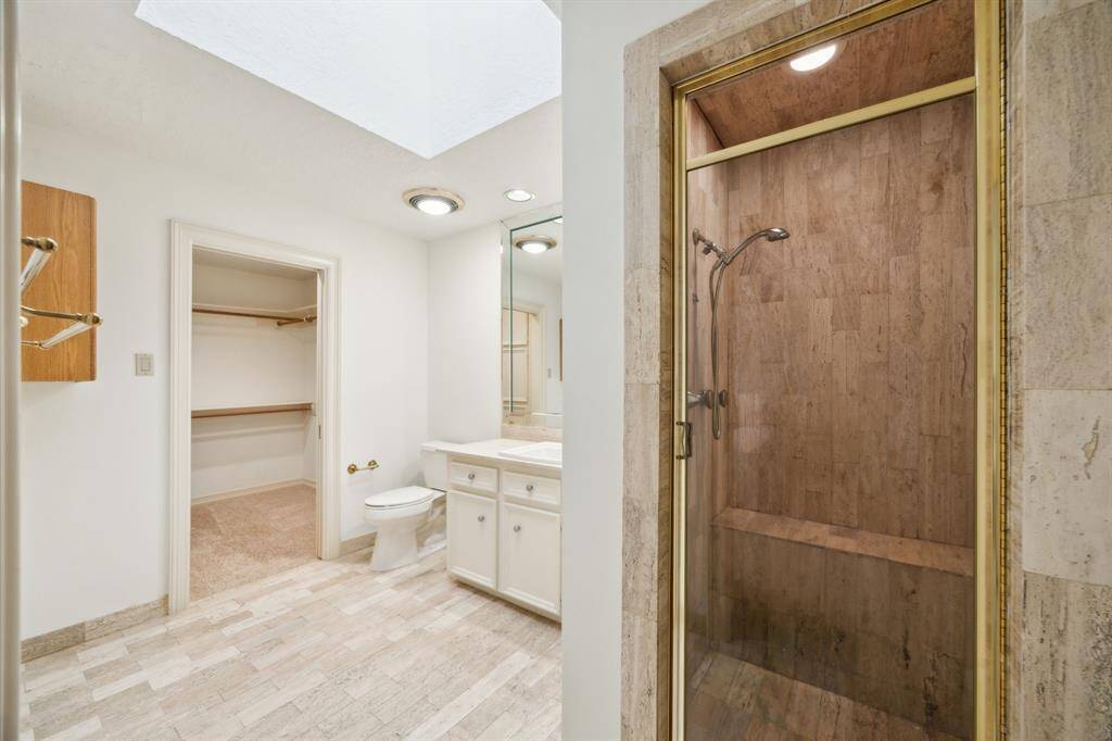 Primary suite boasts two separate baths which could be combined to create a future lavish primary bath.