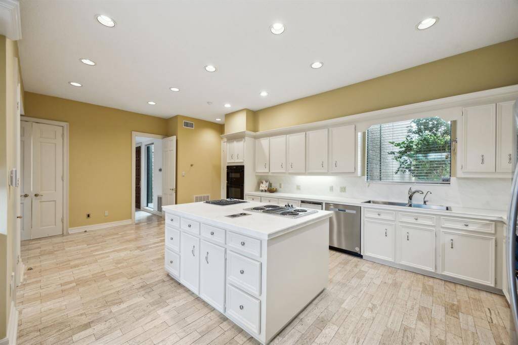 Another perspective of the kitchen showing view towards the entry and access to the attached garage.