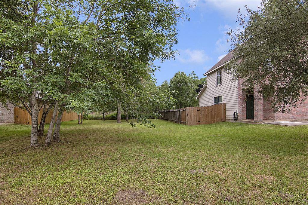 Left side of the property showing how much extra grassy space there is to enjoy