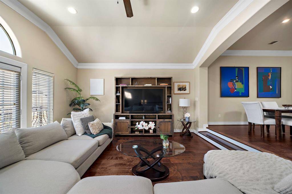 Large windows bring in natural light and the doors to the left lead to a lovely balcony overlooking the front of the home.