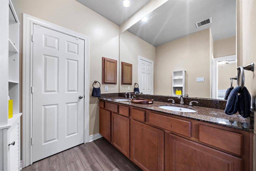The primary bath with double sinks and a walk-in closet.