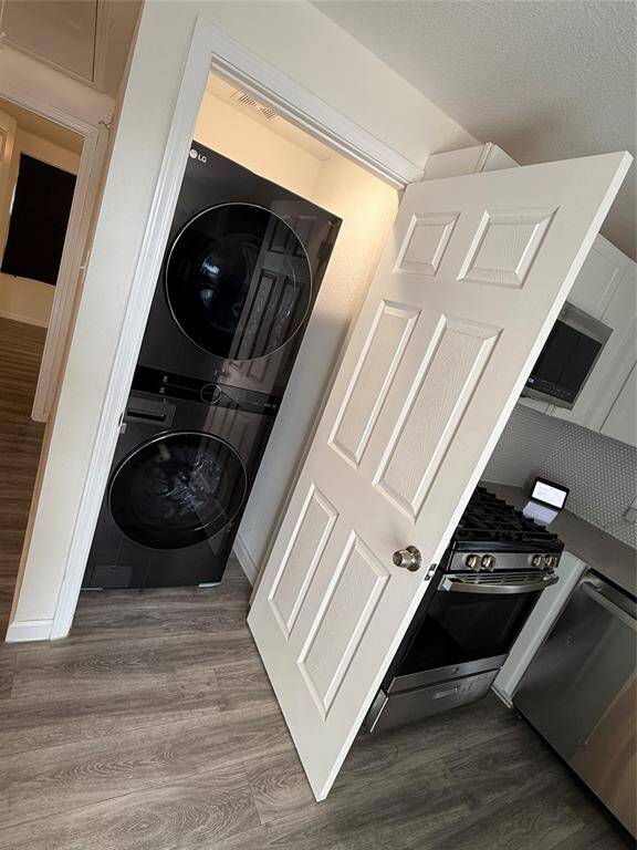 Tucked efficiently near the kitchen, this compact laundry zone is purpose-built to fit a stacked washer and dryer—an intelligent use of space that doesn’t sacrifice convenience.