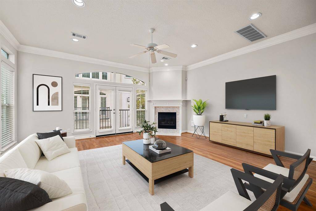 **Virtually Staged** This inviting corner of the living room highlights the cozy gas fireplace framed by classic trim and tile. The space is perfect for relaxing evenings or lively gatherings with friends and family.