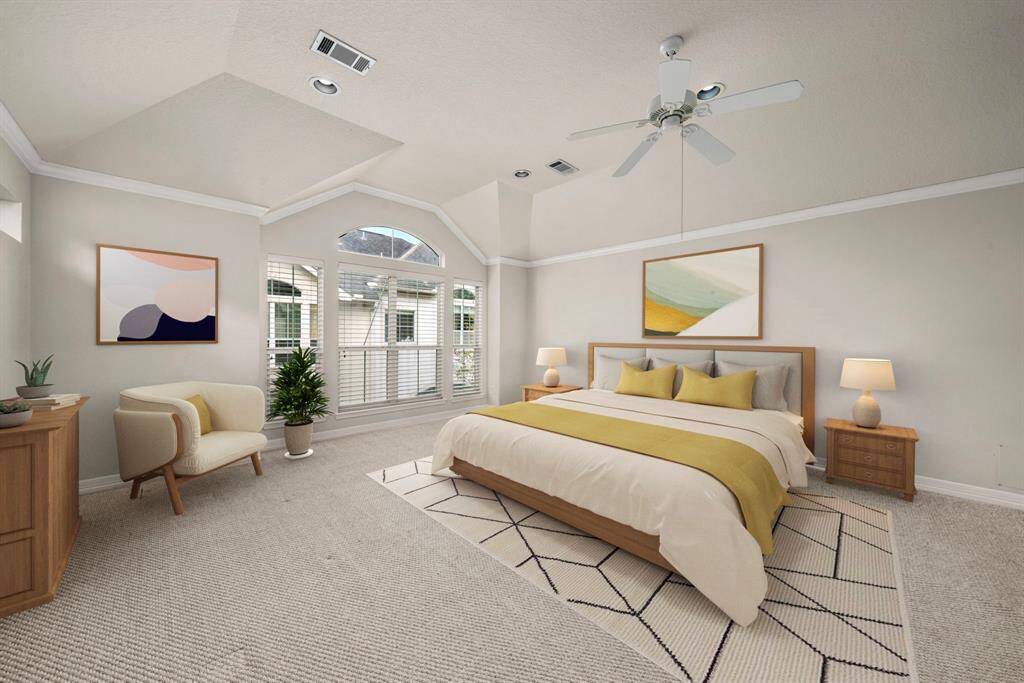 **Virtually Staged** The expansive primary bedroom boasts dramatic vaulted ceilings, crown molding, and a striking arched window that fills the space with natural light. Multiple upper windows maintain privacy while enhancing the room's airy ambiance.