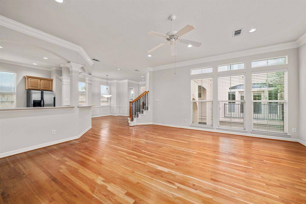 Floor-to-ceiling windows offer beautiful natural light and a serene view, creating a bright and airy ambiance. The seamless flow makes this an ideal setting for both everyday living and entertaining.