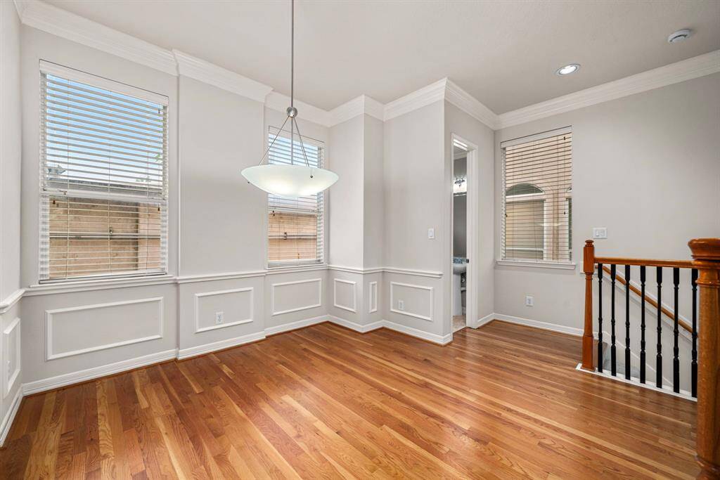 Positioned between the kitchen and staircase, this corner of the home is perfect for everyday dining. Architectural trim and moldings add a refined touch to the space.