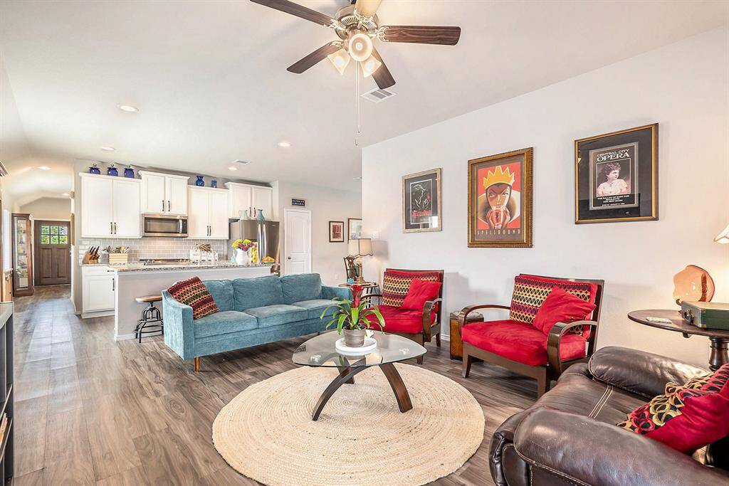 Light-filled and open, the living room offers a seamless flow to the kitchen and dining areas—perfect for everyday living or entertaining guests.