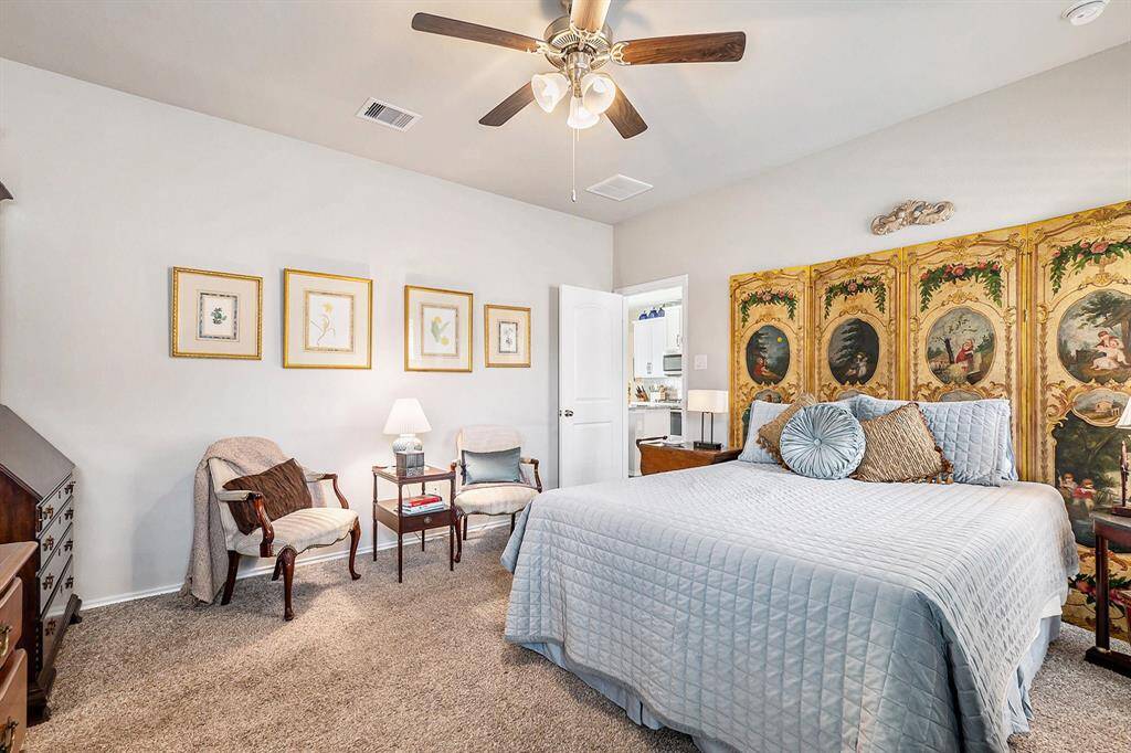Spacious primary suite with large windows, plush carpeting, sitting area, and an ensuite bath—your peaceful retreat at the end of the day.