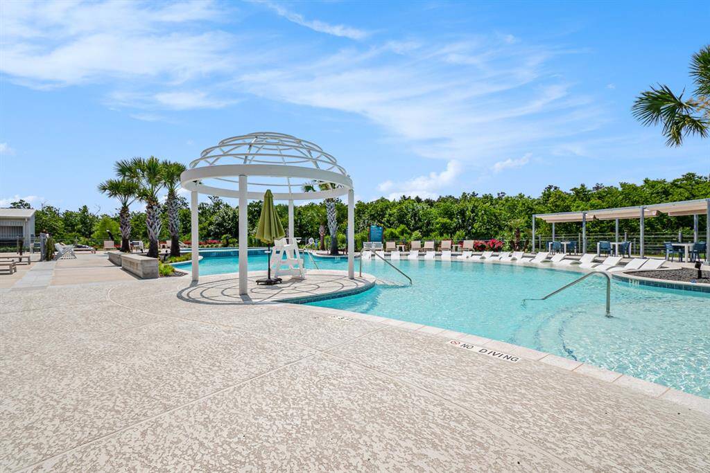 Cool off at the resort-style community pool, complete with lounge areas, shaded seating, and a nearby splash pad for the kids.