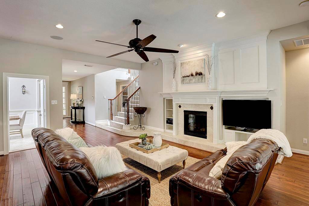 This spacious family room features built-ins, gas fireplace and hardwood floors.