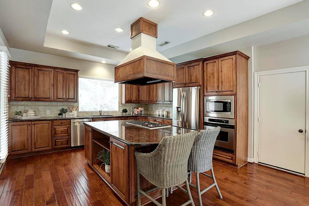 This culinary space features abundant cabinetry and an enormous island which will encourage guests to linger.