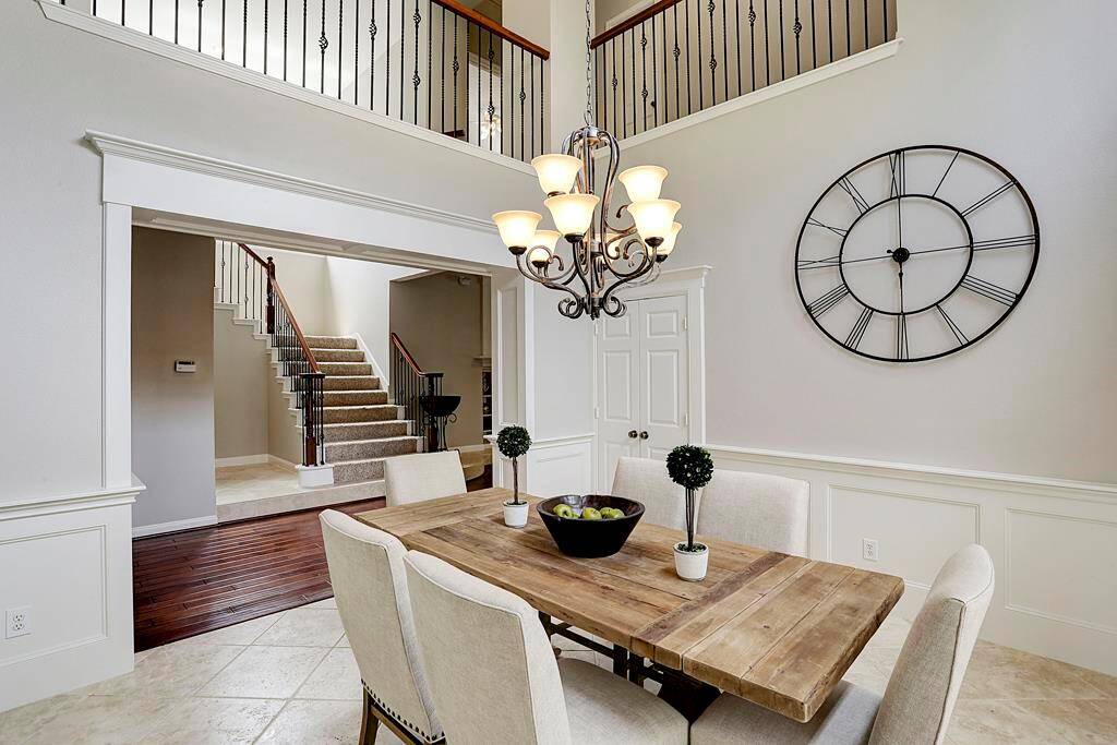 The two story formal dining room is a show stopper.  It features beautiful millwork and wainscoting and was just updated with a new chandelier (not shown in picture).