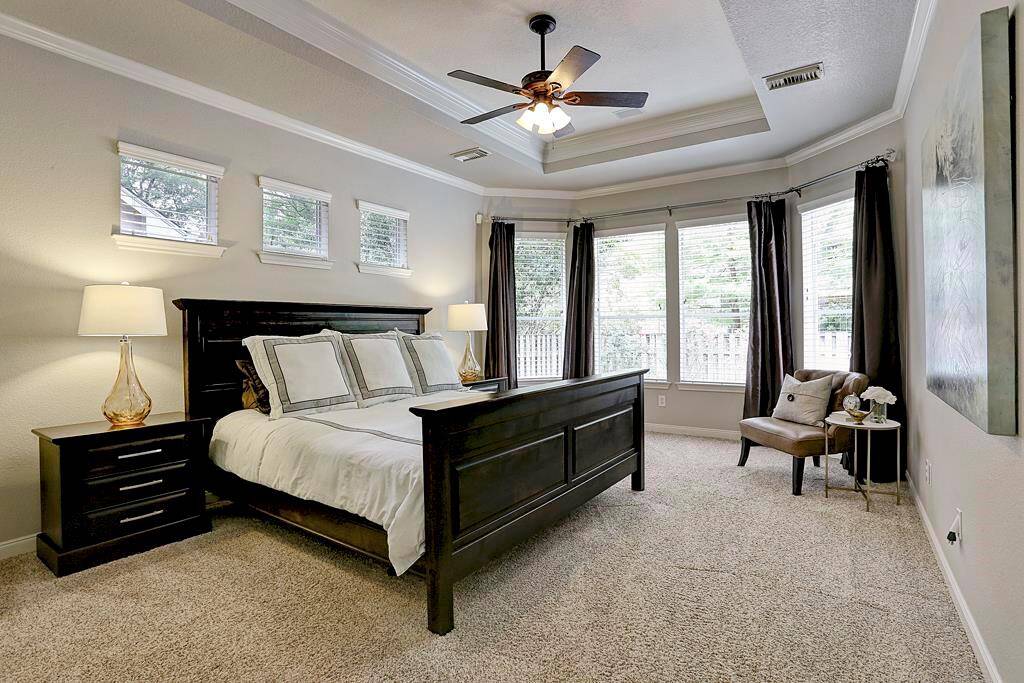 The primary suite is located on the main level.  It enjoys a bay of windows overlooking the pool.  This home also features a second bedroom down, in addition to the primary.