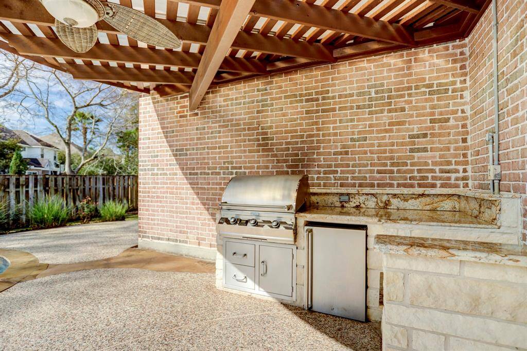 This second outdoor covered space features a kitchen with grill, space for an outdoor mini fridge and granite counters!  (Please note that the refrigerator shown here is NOT included but a tenant may bring their own!)