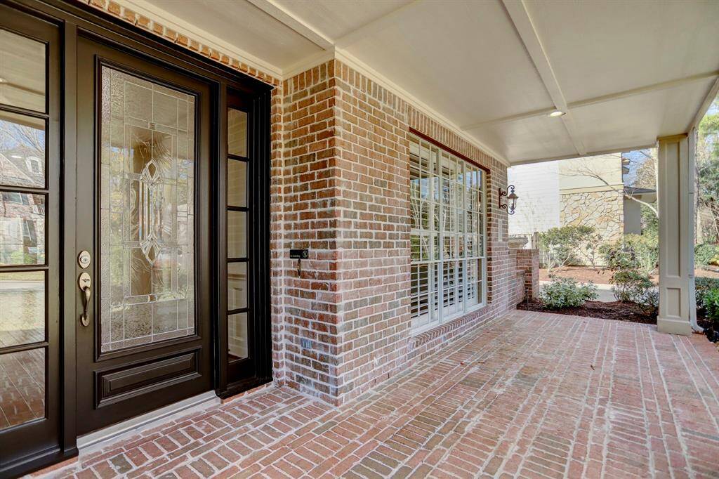 Guests are greeted by a charming brick front porch, perfect for sipping morning coffee or visiting with neighbors while watching children at play.