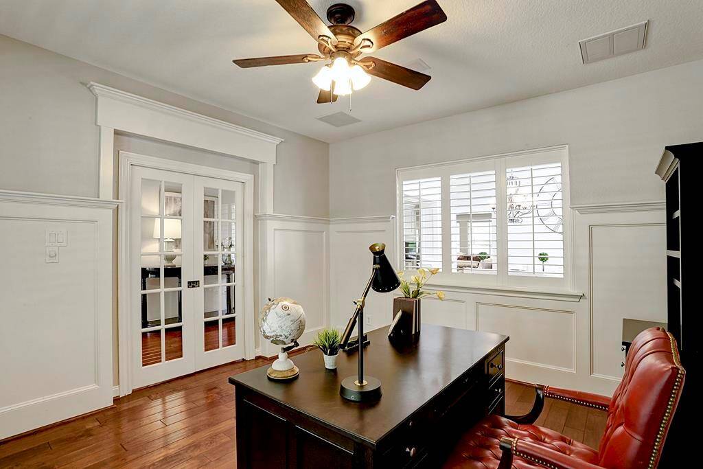The private study boasts wood floors and wainscoting.