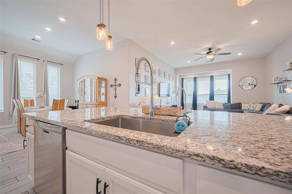 The expansive granite island features an undermount sink and modern fixtures, offering a central workspace for the kitchen. Overlooking the dining and living areas, it’s perfect for casual meals or entertaining guests.The expansive granite island features an undermount sink and modern fixtures, offering a central workspace for the kitchen. Overlooking the dining and living areas, it’s great for casual meals, as well as convenient surface space.