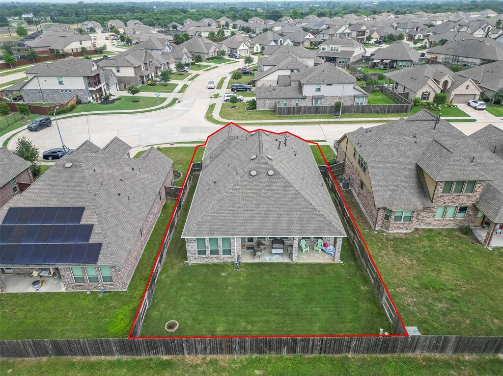 Aerial view highlights the generous lot size with a fully fenced backyard and no rear neighbors. The boundary lines showcase the property's great placement on a quiet, low-traffic street.