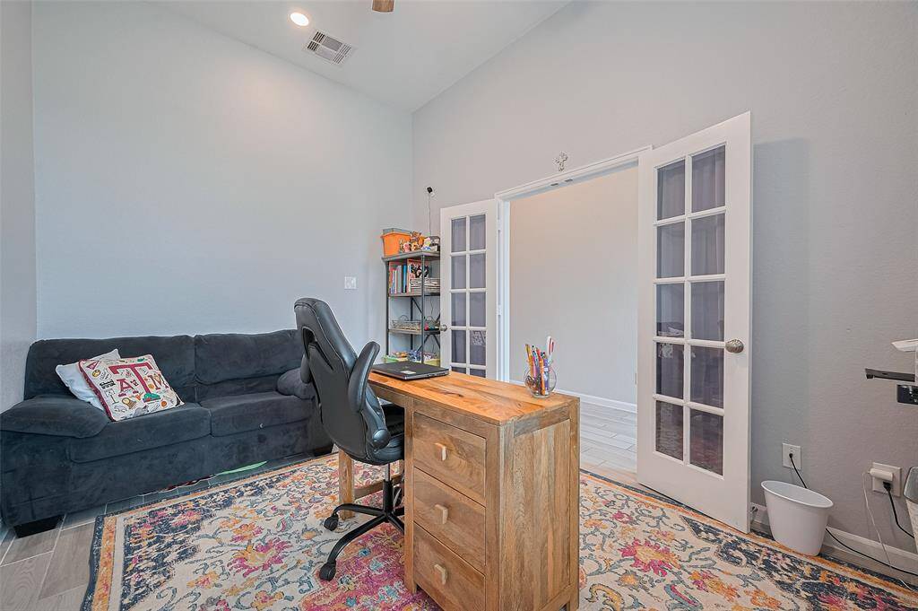 Another view of the study highlights its generous dimensions, high ceilings, and abundant natural light. Neutral wall tones and clean lines contribute to a bright, versatile space suited for work or quiet retreat.