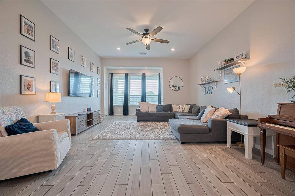 Another view of the great room showcases its generous size and open layout, providing flexibility for various living arrangements. High ceilings enhance the sense of space and create an inviting, expansive feel.