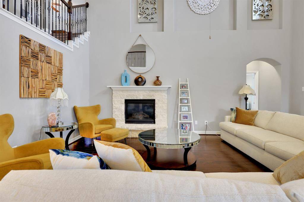 Open-concept living room with gas fireplace and abundant natural light