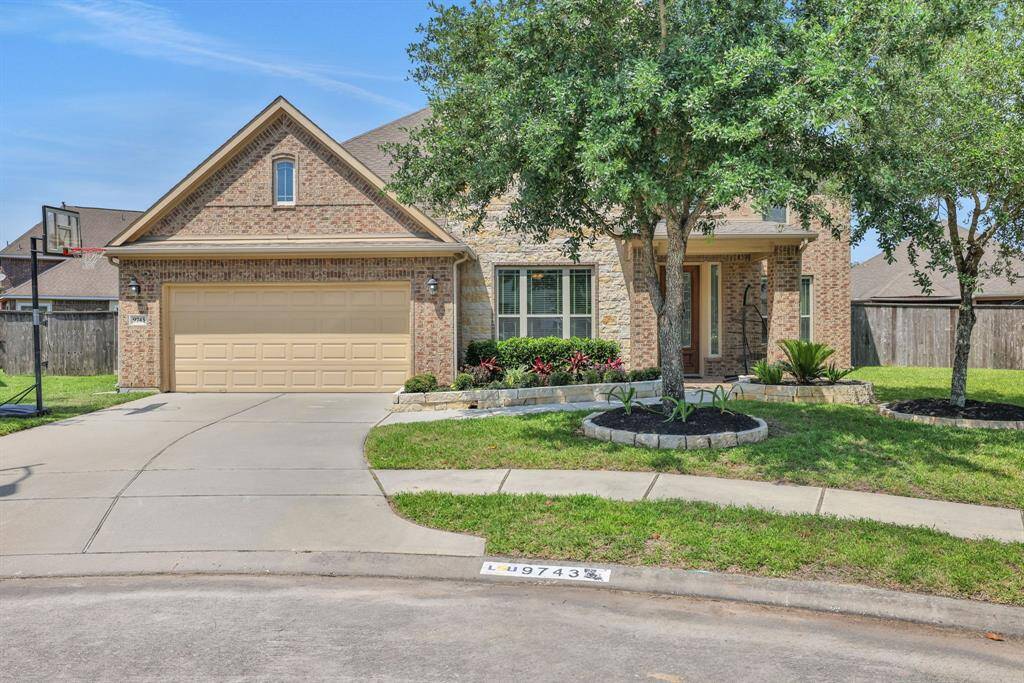 Charming brick home on a quiet cul-de-sac with lush landscaping and great curb appeal