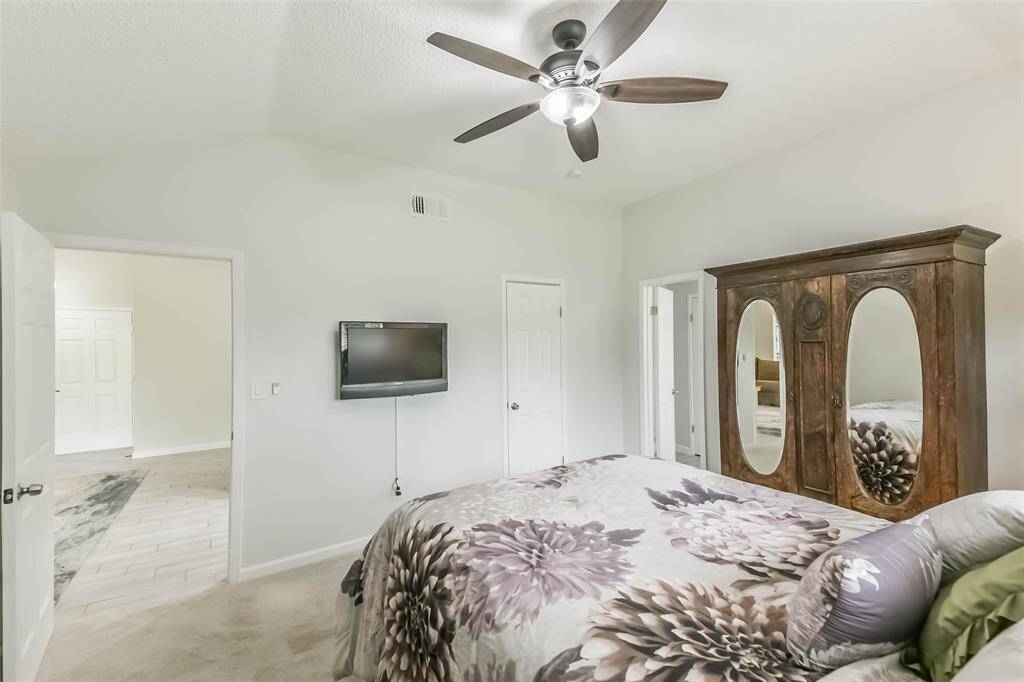 This primary bedroom suite not only has 2 walk-in closets in the ensuite bathroom, but another one in the bedroom itself.