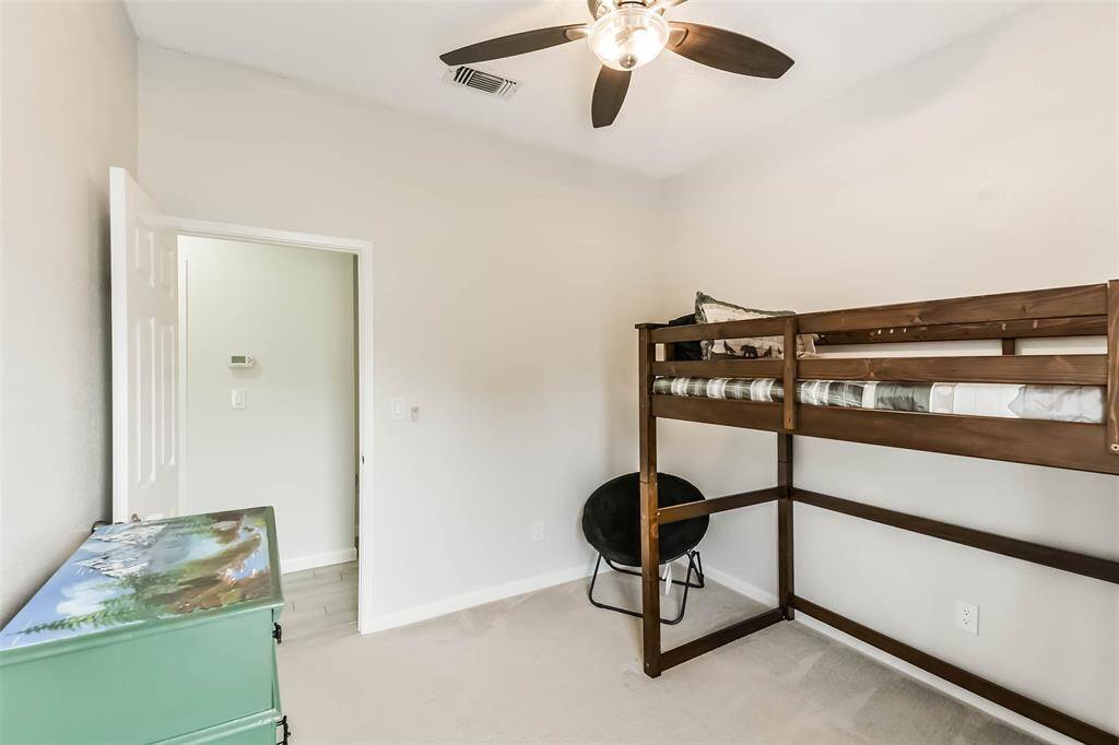 Bedroom two with ceiling fan.