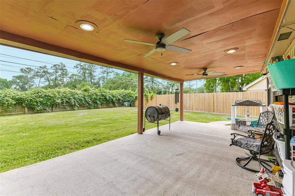 Large covered back porch with ceiling fans