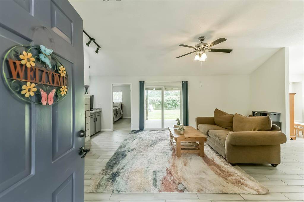 Through the paneled front door and a small entry, the living room is bright and spacious.