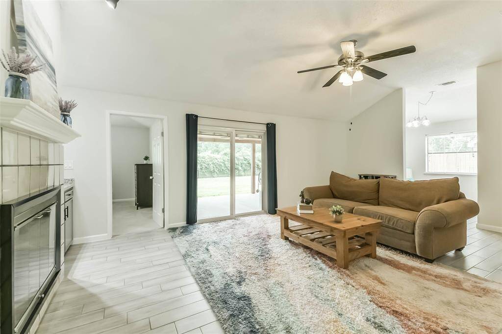 Updated sliding glass doors open to expansive covered back porch.