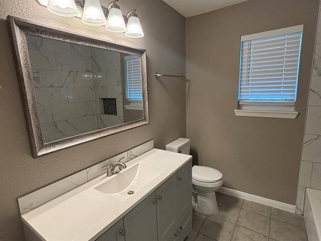 Modern bathroom with a sleek shower/tub combo.