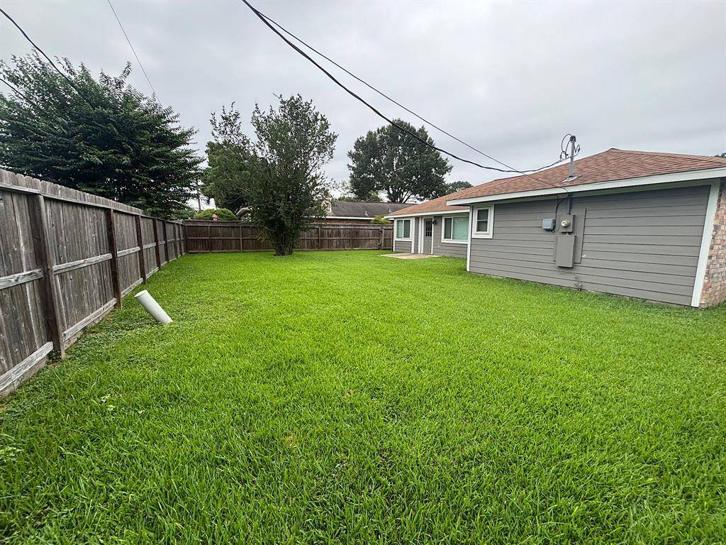 Expansive backyard with lush green lawn, perfect for outdoor activities and relaxation. Fully fenced for privacy and security. Ideal for family gatherings or a peaceful retreat.