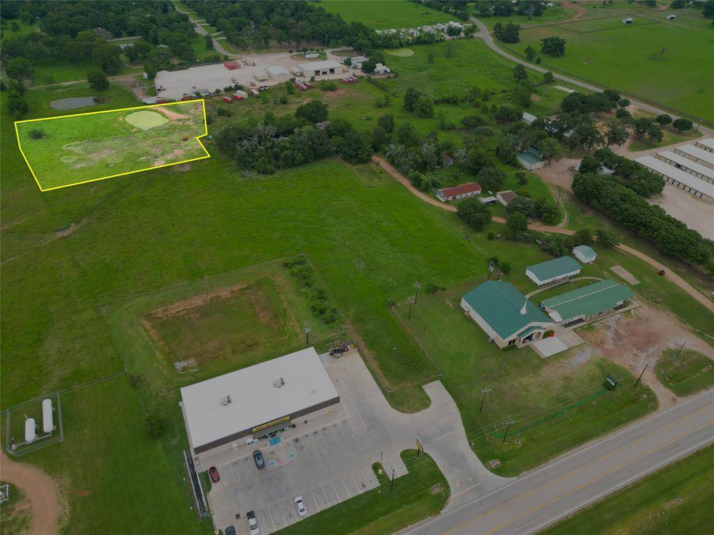 Aerial view with boundary overlay—2-acre tract just off FM 1488 with easement access and high visibility.
