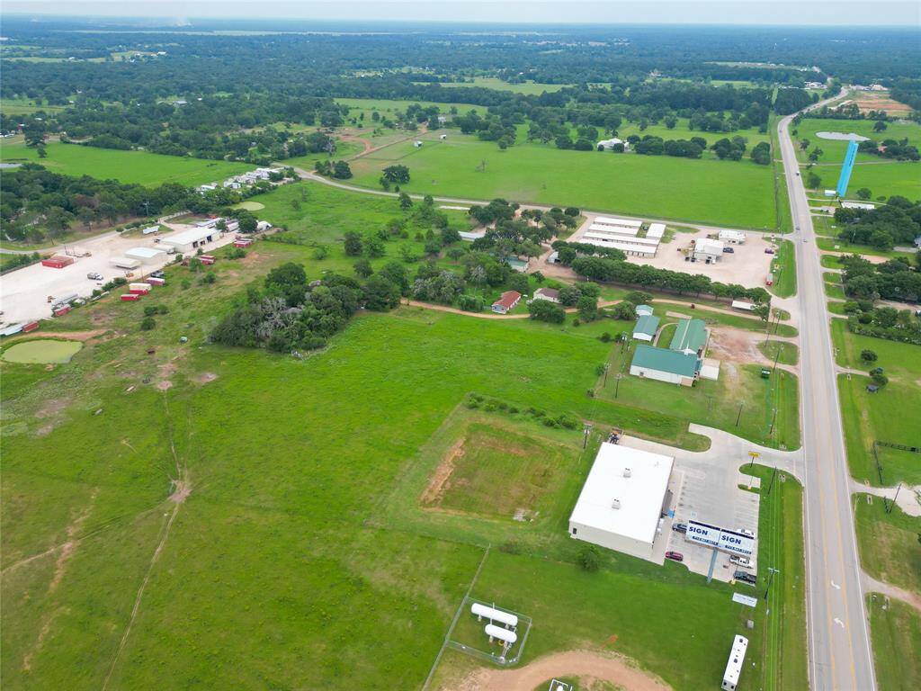 Wide aerial view of the full 2-acre tract located off FM 1488—excellent visibility and development potential.