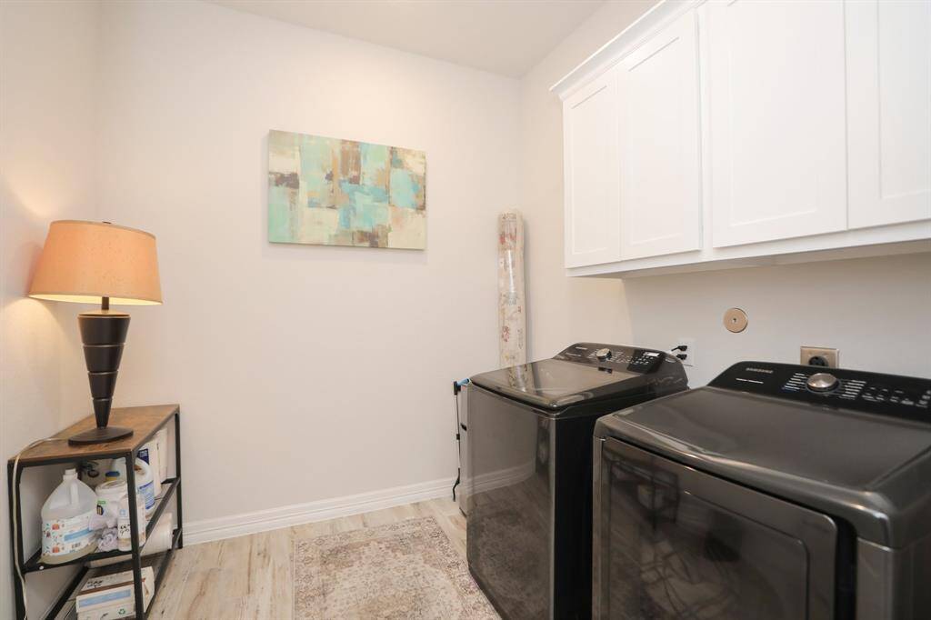 Plenty of storage in this large laundry room.