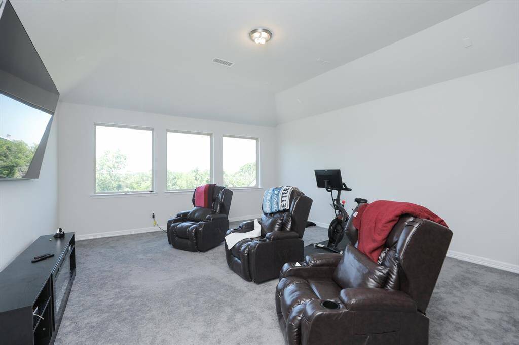 Gameroom upstairs large enough for your enjoyment and large windows over looking the green space behind the yard.