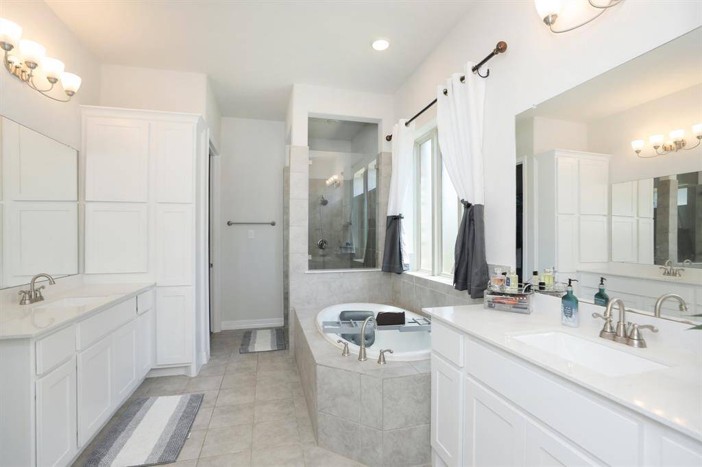 Primary Bathroom downstairs complete with soaking tub and separate shower.