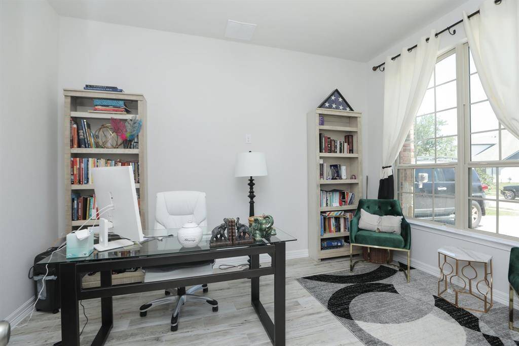 Office has plenty of natural light and a view of the front.