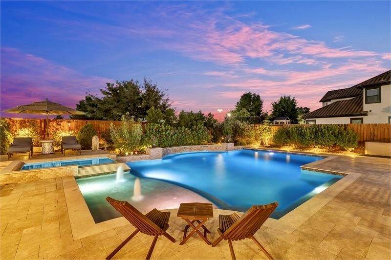 Welcome home to resort-style living in this stunning backyard oasis featuring a sparkling pool, relaxing spa, and elegant patio seating.