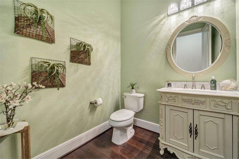Half bath with thoughtful design is conveniently located by the living room.