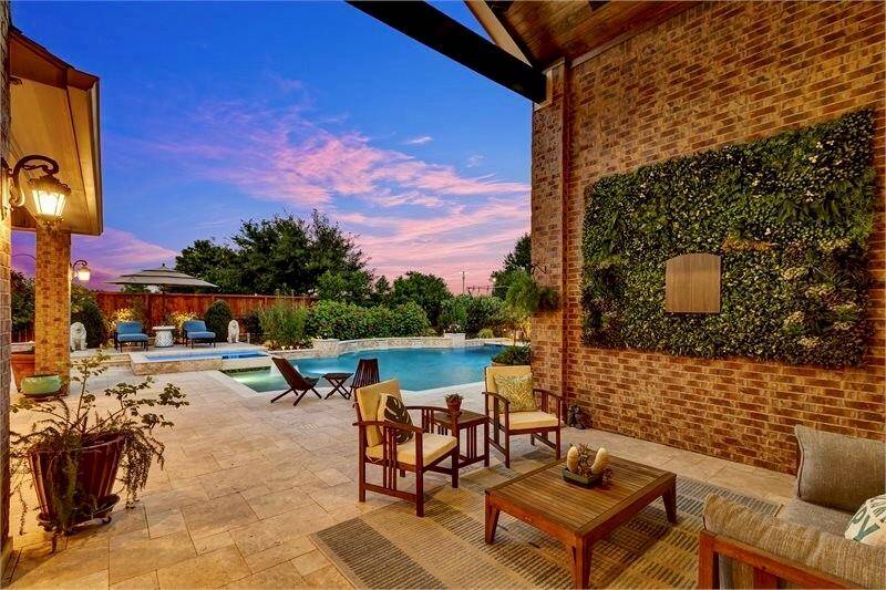 Breathtaking views of the backyard retreat and the inviting covered back porch.